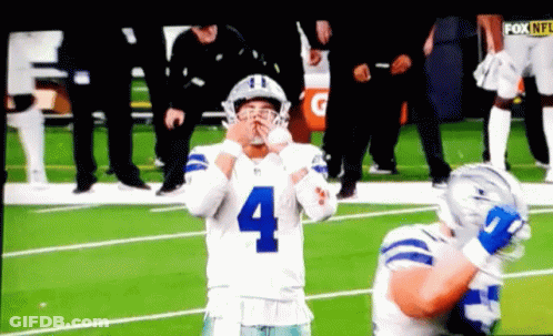 A Football Player With The Number 4 On His Jersey Stands On The Field GIF
