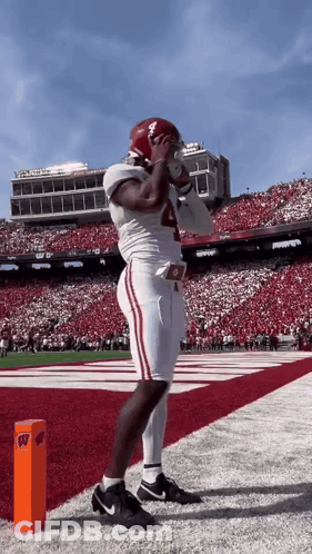 A Football Player With The Number 4 On His Jersey Stands On The Field GIF