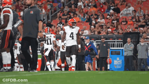 A Football Player With The Number 4 On His Jersey Walks On The Field GIF