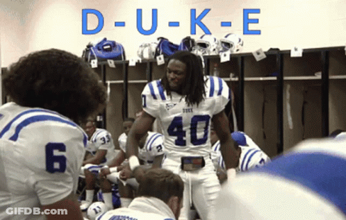 A Football Player With The Number 40 On His Jersey Stands In A Locker Room GIF