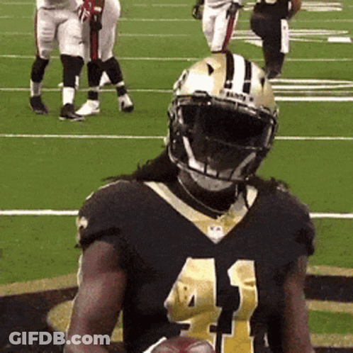 A Football Player With The Number 41 On His Jersey Is Holding A Football GIF