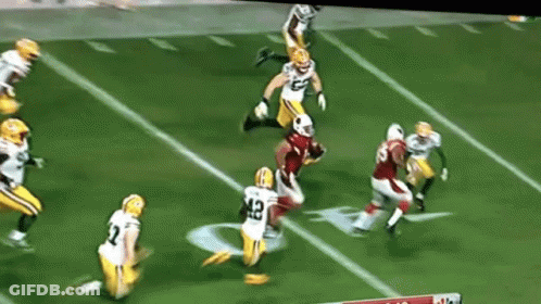 A Football Player With The Number 42 On His Jersey Is Being Tackled By Another Player GIF