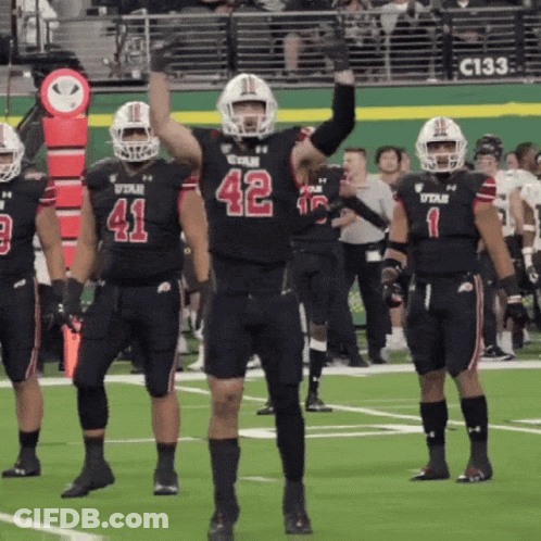 A Football Player With The Number 42 On His Jersey Stands On The Field GIF