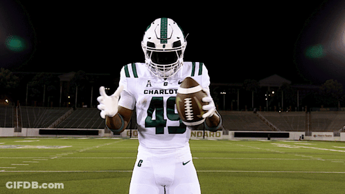 A Football Player With The Number 49 On His Jersey Holds A Football GIF