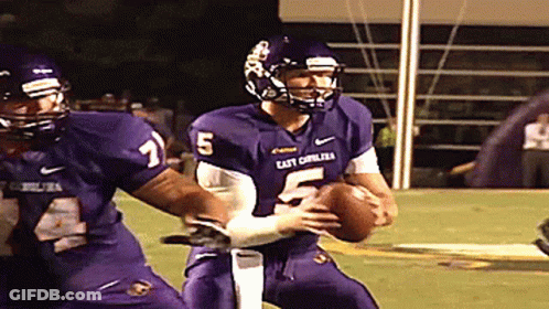 A Football Player With The Number 5 On His Jersey Is Being Tackled GIF
