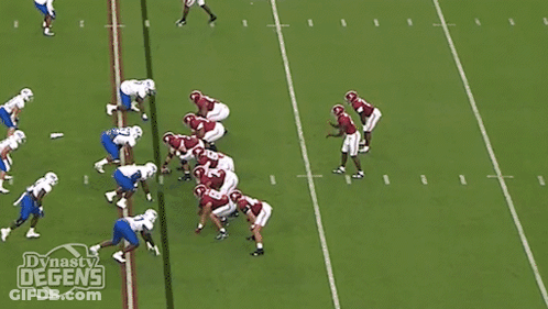A Football Player With The Number 5 On His Jersey Is Being Tackled GIF