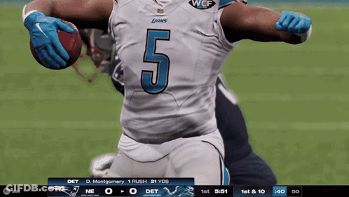 A Football Player With The Number 5 On His Jersey Is Holding A Ball GIF
