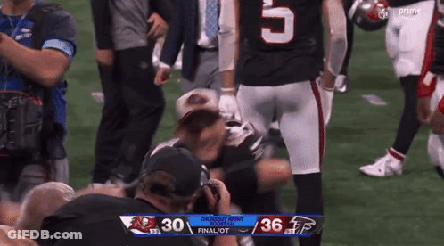 A Football Player With The Number 5 On His Jersey Is Kneeling On The Field GIF