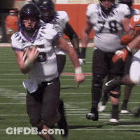 A Football Player With The Number 5 On His Jersey Is Running With A Ball GIF