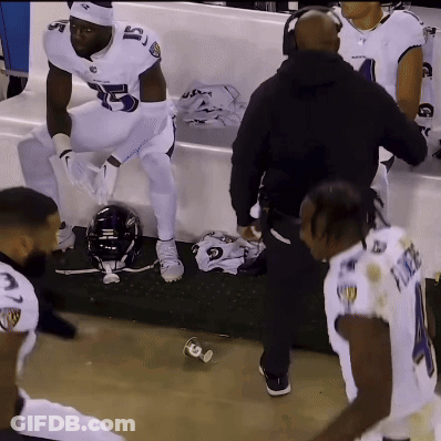 A Football Player With The Number 5 On His Jersey Is Sitting On A Bench GIF