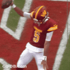 A Football Player With The Number 5 On His Jersey Is Throwing The Ball GIF