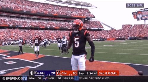 A Football Player With The Number 5 On His Jersey Stands On The Field GIF