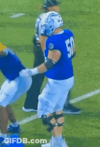 A Football Player With The Number 50 On His Jersey Is Being Tackled By Another Player GIF