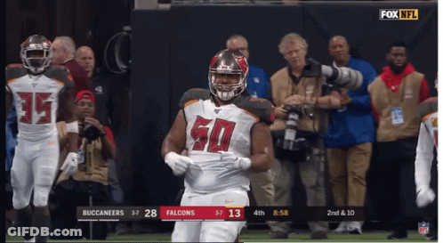 A Football Player With The Number 50 On His Jersey Stands On The Field GIF