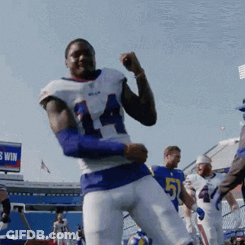 A Football Player With The Number 51 On His Jersey Is Dancing GIF