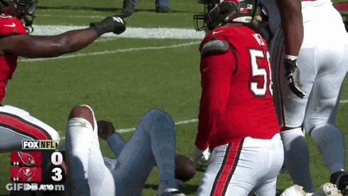 A Football Player With The Number 51 On His Jersey Is Laying On The Field GIF