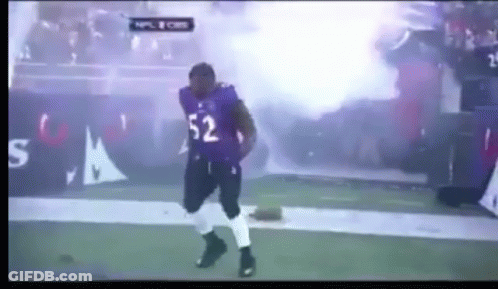 A Football Player With The Number 52 On His Jersey Is Dancing On The Field GIF