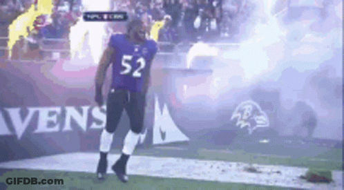 A Football Player With The Number 52 On His Jersey Is Walking On The Field GIF