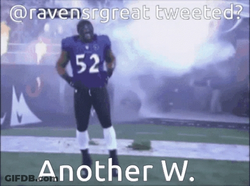 A Football Player With The Number 52 On His Jersey Stands On A Field GIF