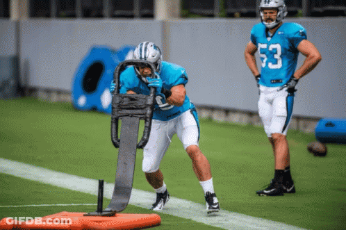 A Football Player With The Number 53 On His Jersey Is Being Pushed By A Sled GIF