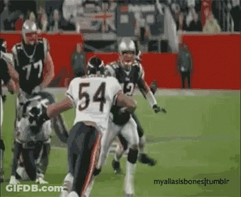 A Football Player With The Number 54 On His Jersey Is Running On The Field . GIF