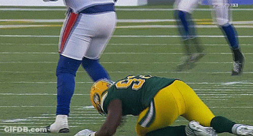 A Football Player With The Number 55 On His Jersey Is Laying On The Field GIF
