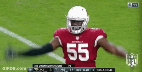 A Football Player With The Number 55 On His Jersey Is Standing On The Field GIF
