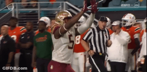 A Football Player With The Number 58 On His Jersey Is Running Towards A Referee GIF