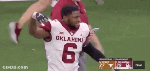A Football Player With The Number 6 On His Jersey Is Running On The Field . GIF