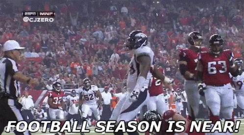 A Football Player With The Number 63 On His Jersey Is Running On A Field GIF
