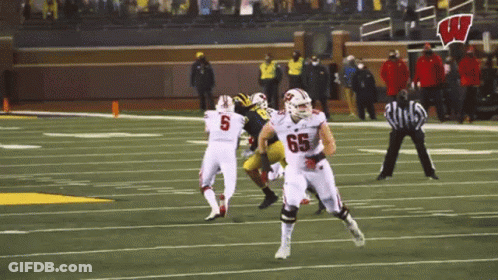 Football Player With Number 65 Running GIF