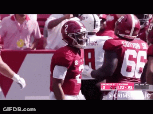 A Football Player With The Number 66 On His Jersey Talks To Another Player GIF