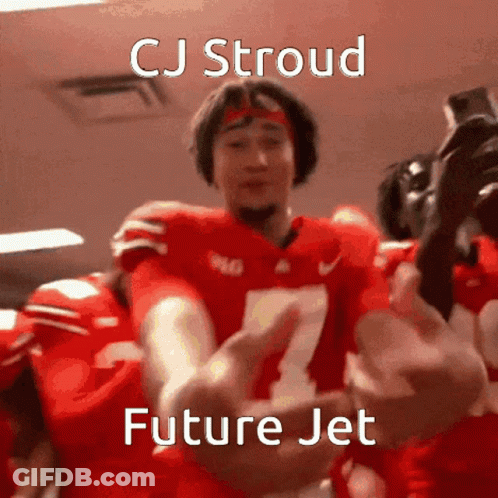 A Football Player With The Number 7 On His Jersey Is Being Hugged By His Teammates . GIF