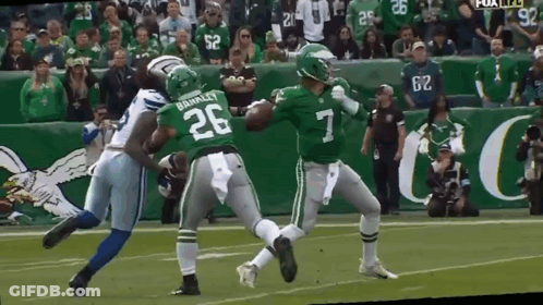 A Football Player With The Number 7 On His Jersey Is Being Tackled By Another Player GIF