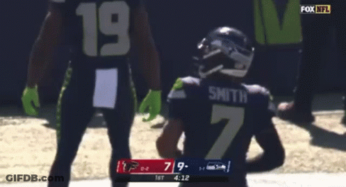 A Football Player With The Number 7 On His Jersey Is Running With The Ball GIF