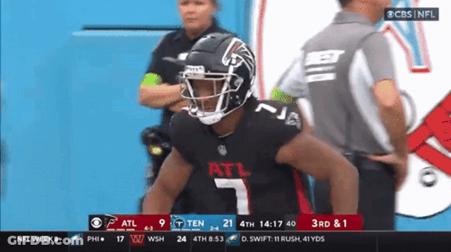 A Football Player With The Number 7 On His Jersey Stands In Front Of A Referee GIF