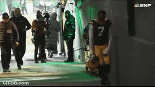 A Football Player With The Number 7 On His Jersey Walks Through A Tunnel GIF