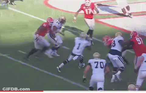 A Football Player With The Number 70 On His Jersey Is Jumping In The Air GIF