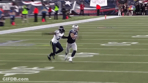 A Football Player With The Number 8 On His Jersey Is Running On A Field GIF
