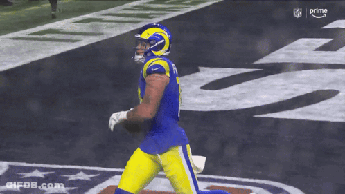 A Football Player With The Number 8 On His Jersey Is Running With The Ball GIF
