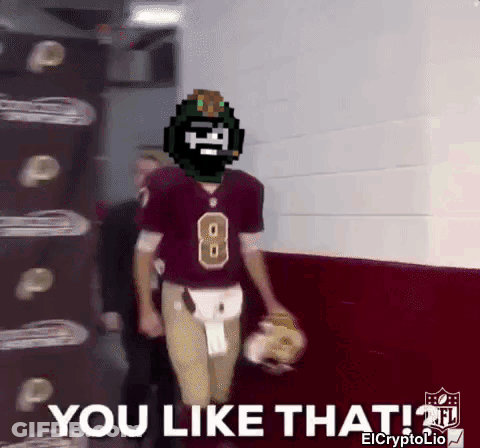 A Football Player With The Number 8 On His Jersey Is Walking Down A Hallway GIF