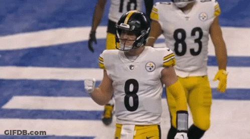 A Football Player With The Number 8 On His Jersey Is Walking On The Field GIF