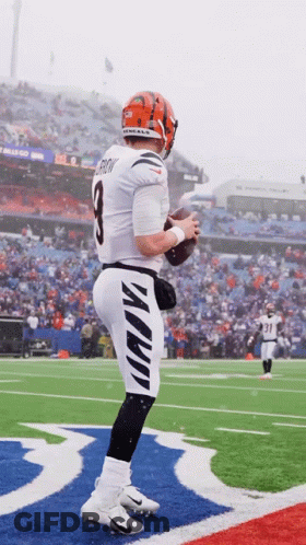 A Football Player With The Number 8 On His Jersey Stands On A Field GIF