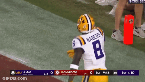 A Football Player With The Number 8 On His Jersey Stands On The Field GIF