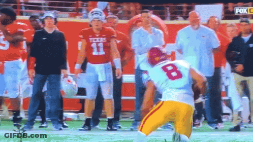 A Football Player With The Number 8 On His Jersey Stands On The Field GIF