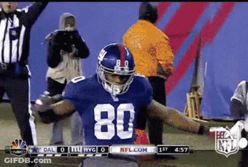 A Football Player With The Number 80 On His Jersey Is Celebrating GIF