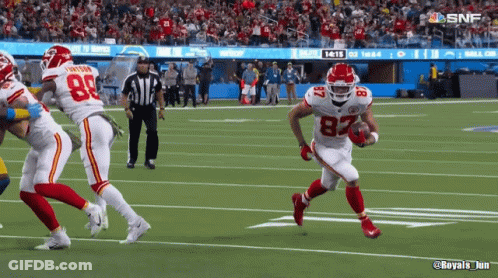 A Football Player With The Number 82 On His Jersey Runs With The Ball GIF