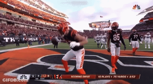 A Football Player With The Number 85 On The Back Of His Jersey Is Running On The Field GIF