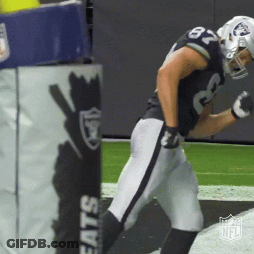 A Football Player With The Number 87 On His Jersey Is Running On The Field GIF