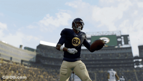 A Football Player With The Number 87 On His Jersey Is Throwing A Ball GIF